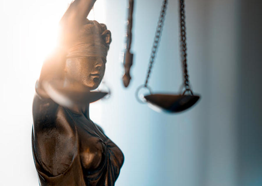 Statue of Justice with scales in lawyer office. Legal law, advice and justice concept